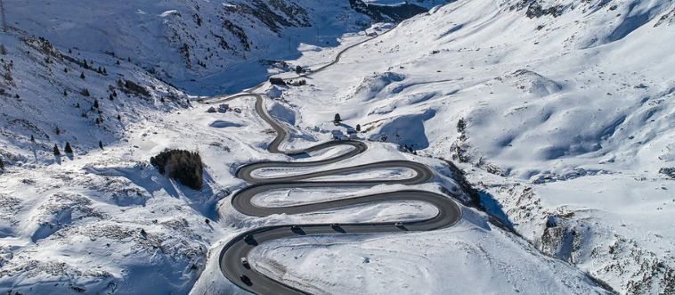 Identify the crucial maneuver required for navigating the punishing, hairpin turns of the European Alps.