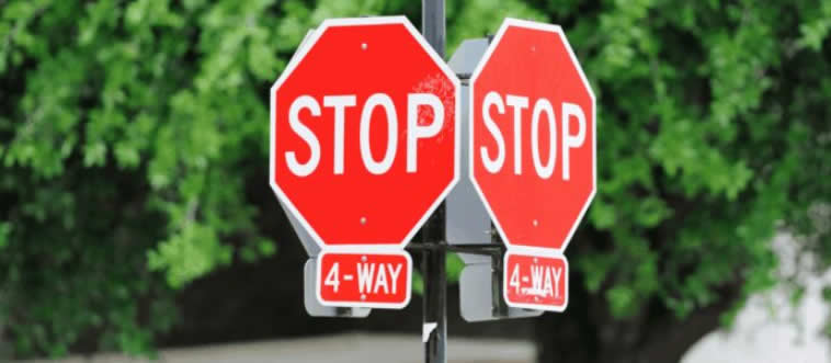 Behold a four-way stop intersection. Which driver claims the legal right of way?