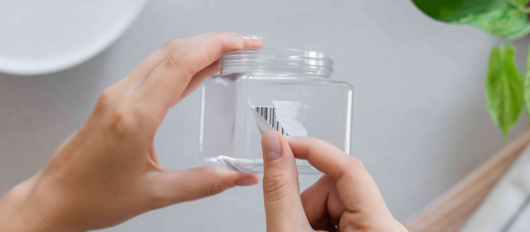 What is the simplest method to strip a tenacious sticker off glass?