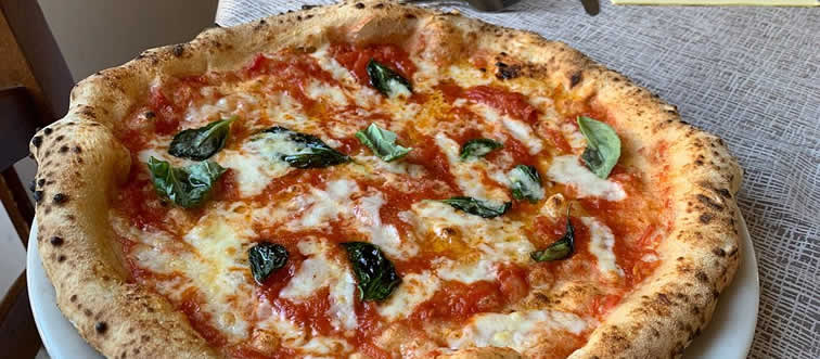 What nation claims the Pizza as its legendary culinary export?